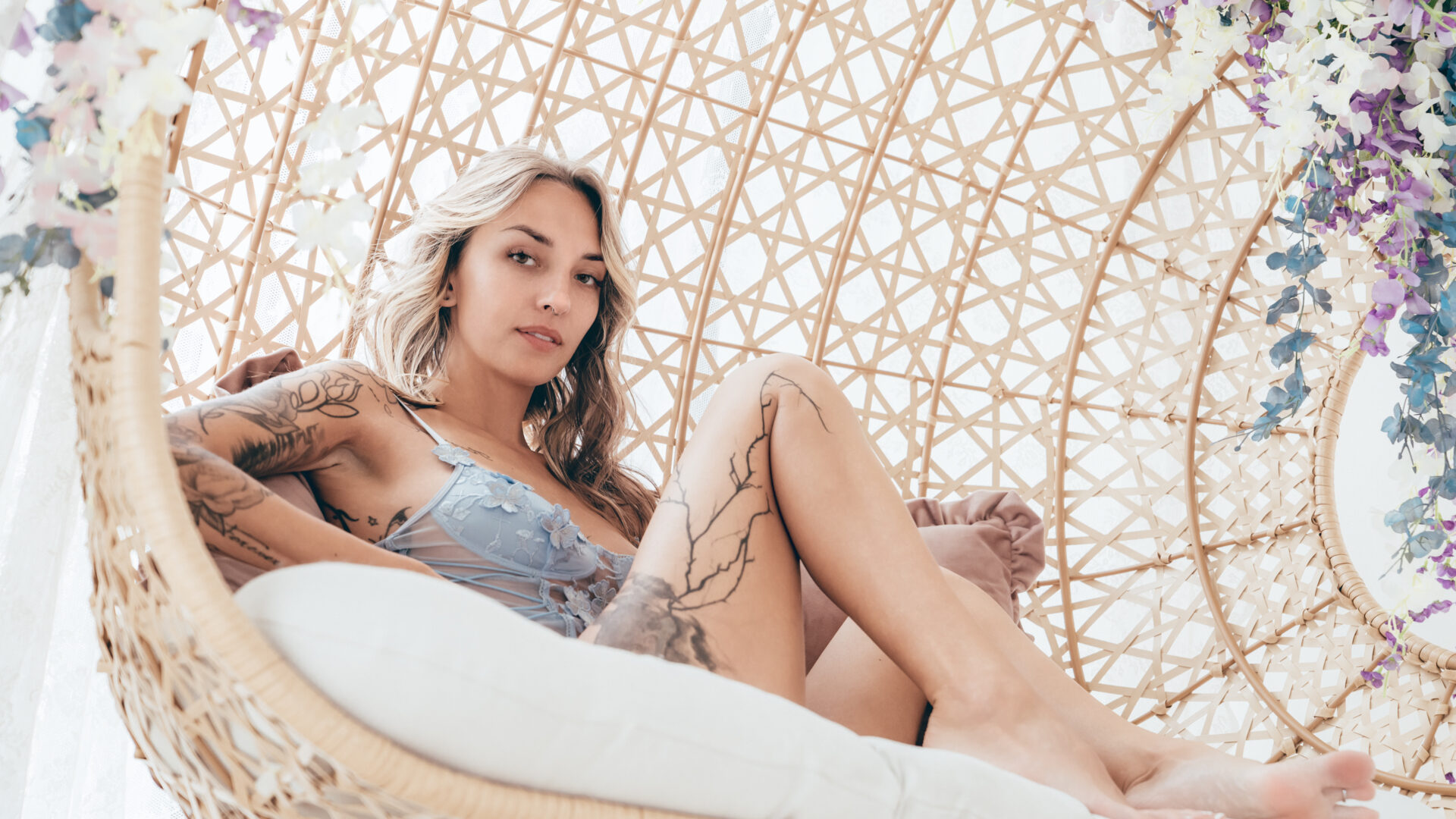 Boudoir portrait of Ashley in blue lingerie surrounded by soft pastel colors downtown Phoenix Arizona