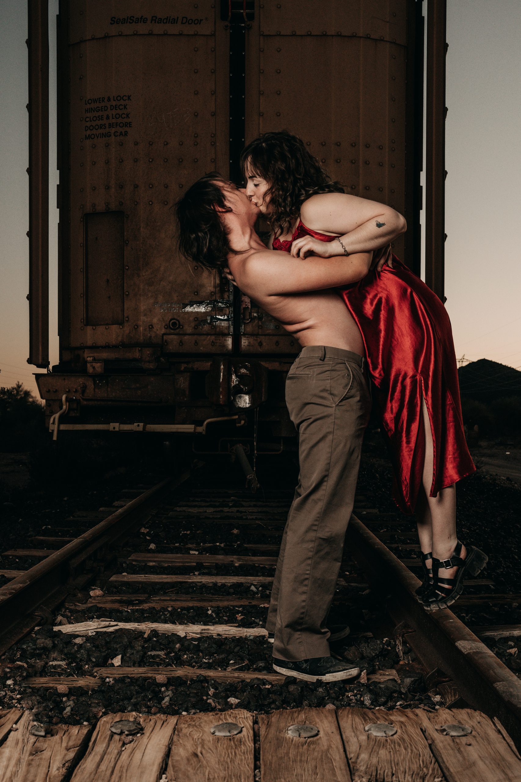 Outdoor couples boudoir photo of CJ and Arrie on a ranch near Buckeye Arizona at sunset