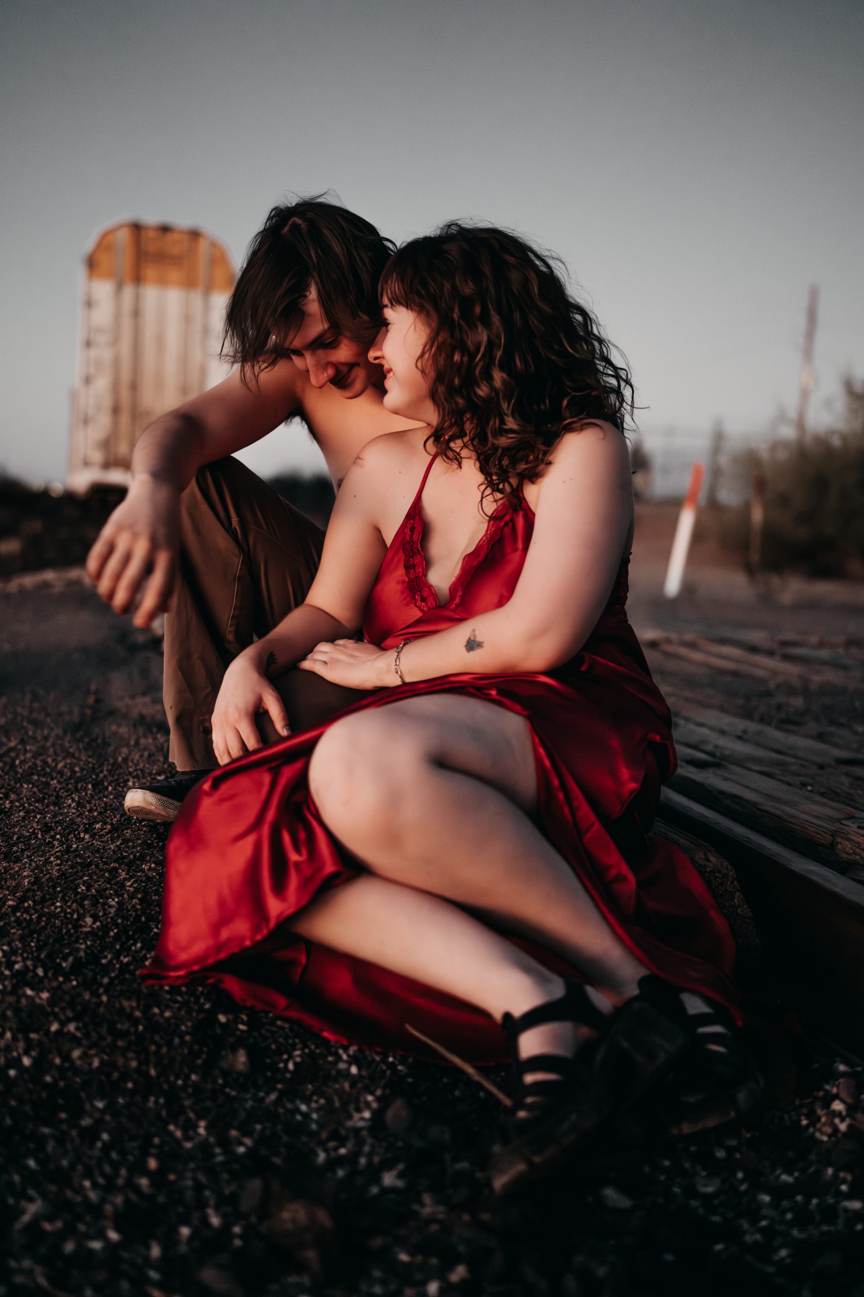 Boudoir portrait of couple CJ and Arrie walking through a ranch field near Buckeye Arizona